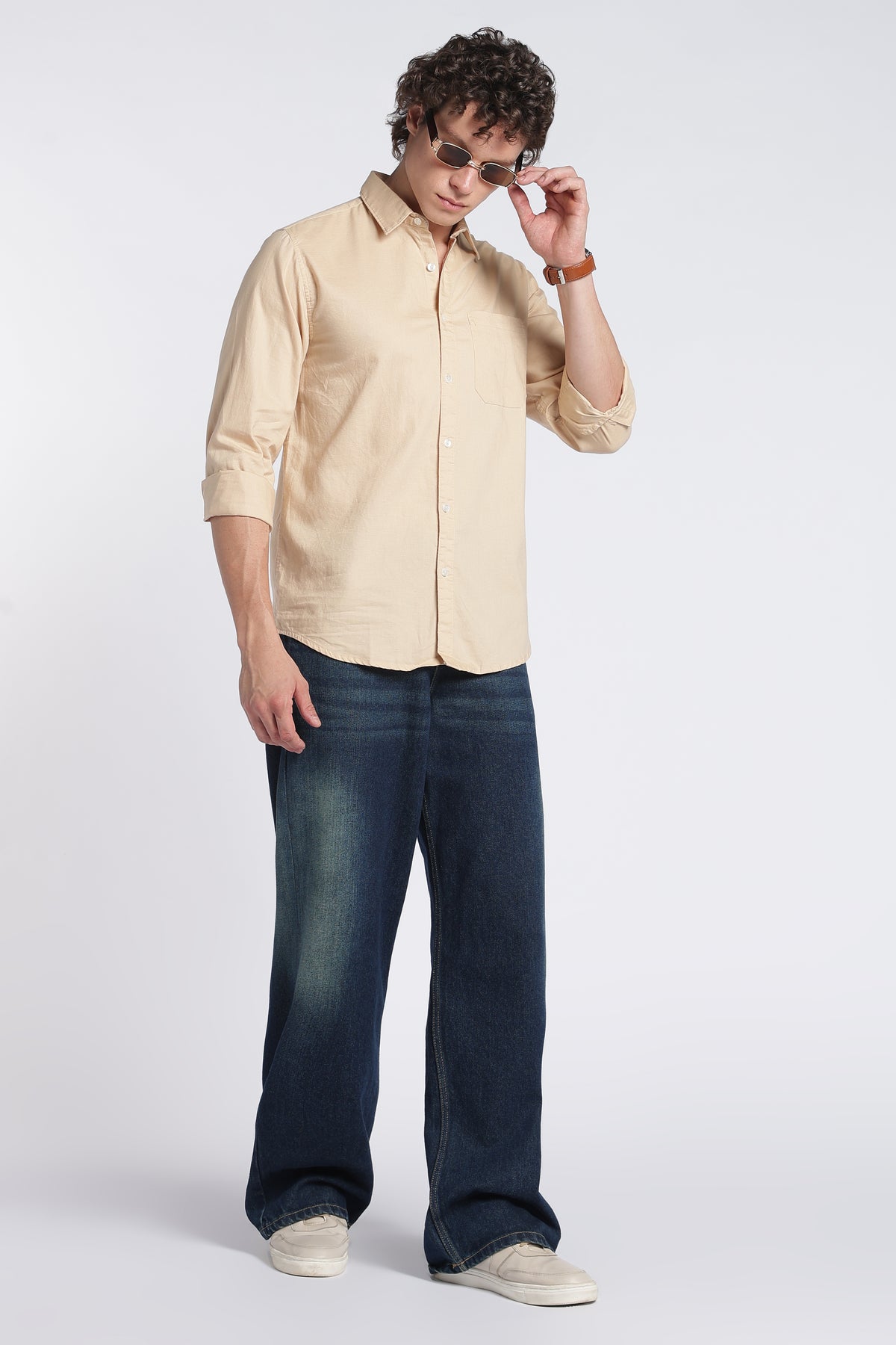 Close-up of collar, buttons and chest pocket on light brown shirt